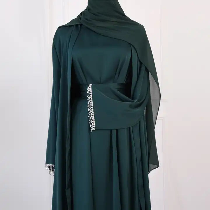 The Danya Diamond Dazzle Open Abaya Set (2-Piece Set) is a stunningly elegant open abaya set made of satin and with a dazzling diamond cuff sleeve finish. This set inlcudes a sleeveless inner slip maxi dress and a matching maxi long sleeve kimono open abaya dress with adiamond sleeve finish design