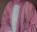 this gorgeous grey abaya is adorned with pearls, champagne, and bronze diamond work on the front and sleeves.