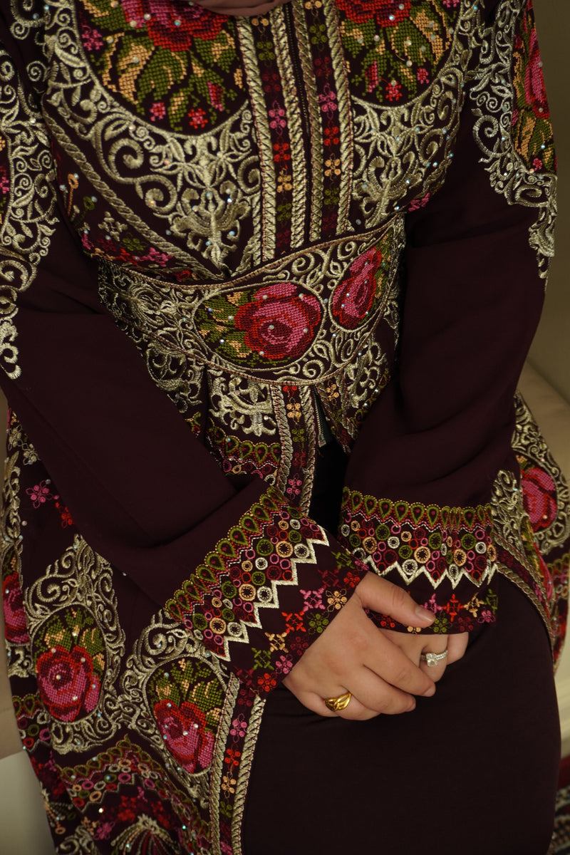 Our Zaytoon Embroidered Palestinian Kaftan Thobe is a beautiful dress for your special occasion! It is luxerious, elegant and perfect for your Palestinian katib ktab or wedding. It is a dress with beautiful floral or oriental tatreez, embedded jewels and a tatreez belt that can be adjusted as you wish!