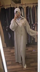 A luxury abaya with embellished gold crystals that cascade down the front of the garment.