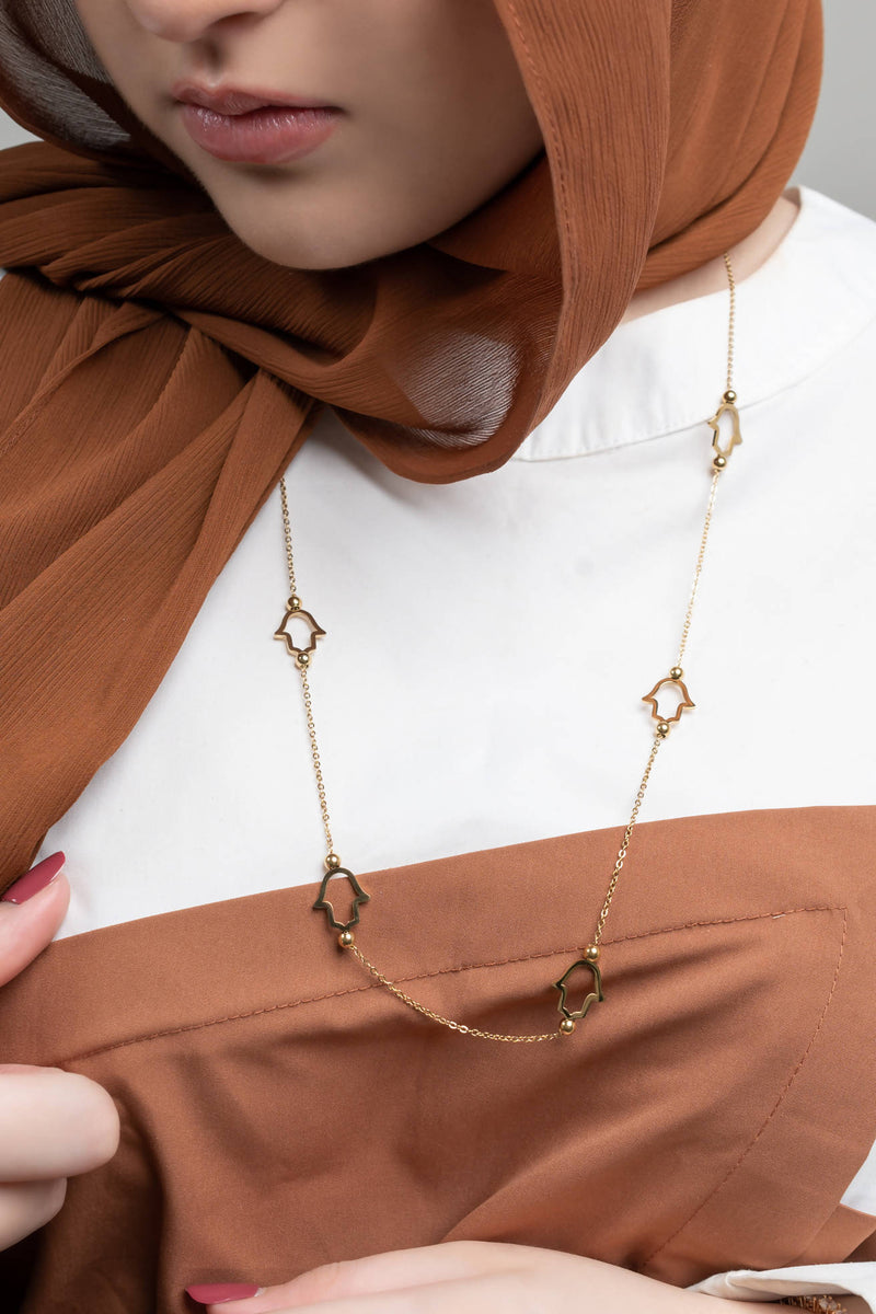 Woman wearing Heavenly Hand of Fatima Necklace gold