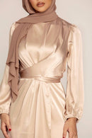 This exclusive modest gown features an elegant tie neckline with a fit and flare silhouette, crafted in premium Satin Nida, a quality, durable material.