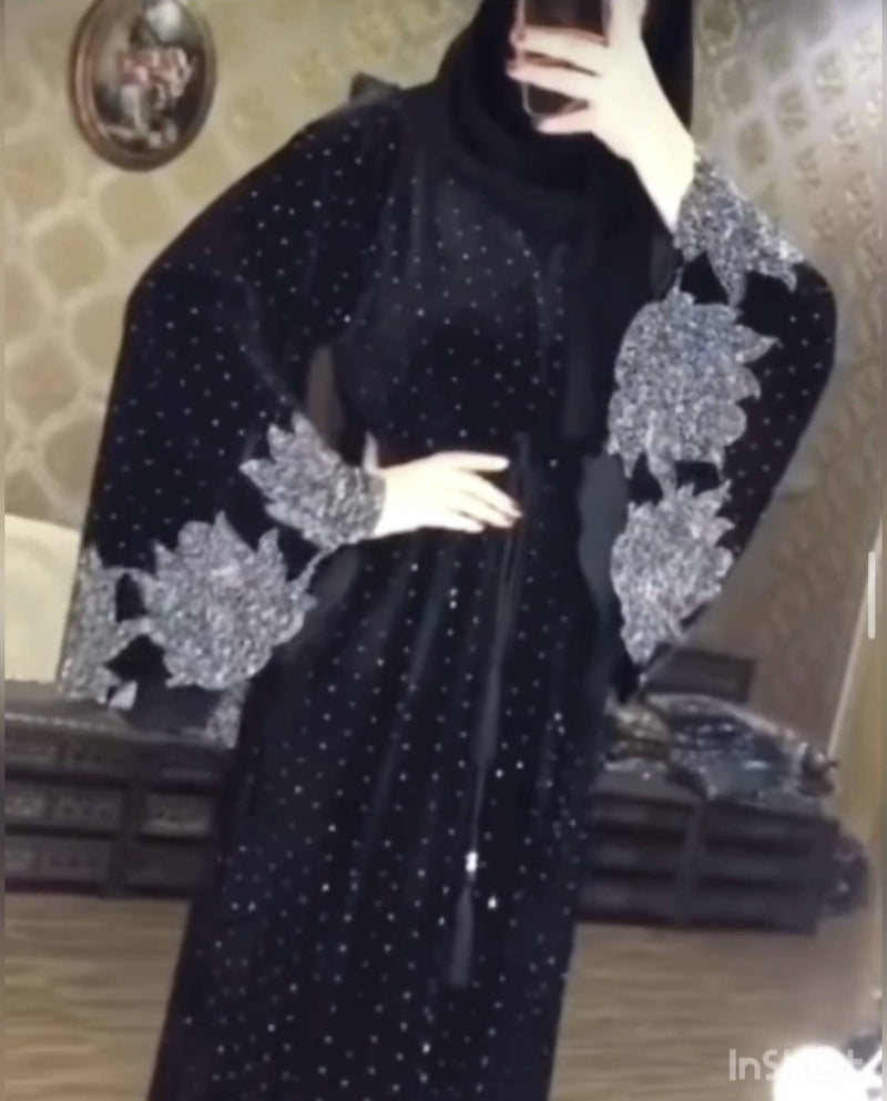 Look luxurious in this beautiful black abaya! It has diamond work on the sleeves and bottom as well as a belt in the middle.