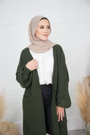 Woman wears Nadha Fares Knit Cardigan rich green