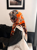 Woman wearing Golden Night Satin Hijab orange brown