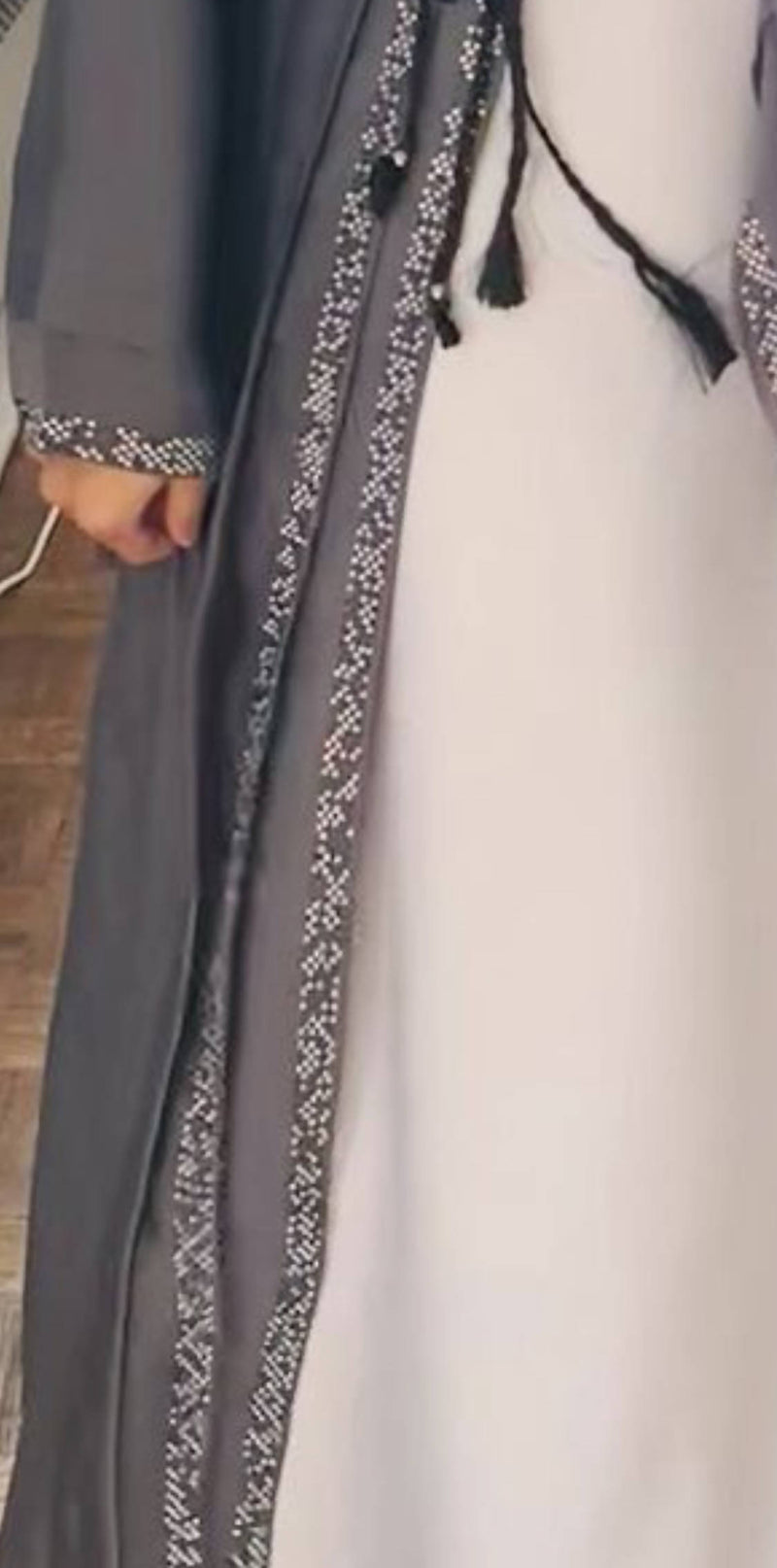 this gorgeous grey abaya is adorned with pearls, champagne, and bronze diamond work on the front and sleeves.