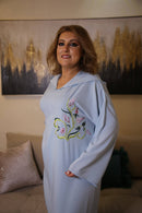 Woman wears handmade light Blue Jalabiya Swarovski stones