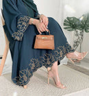 Show up to work looking stylish in this beautiful abaya with embroidery and diamond details on the front!