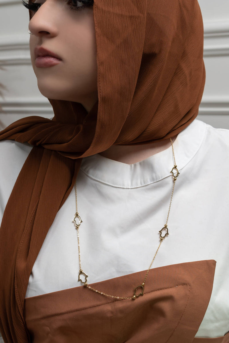 Model wearing Heavenly Hand of Fatima gold necklace