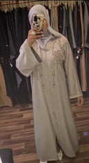 A luxury abaya with embellished gold crystals that cascade down the front of the garment.