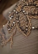 A luxury abaya with embellished gold crystals that cascade down the front of the garment.