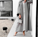 this gorgeous grey abaya is adorned with pearls, champagne, and bronze diamond work on the front and sleeves.